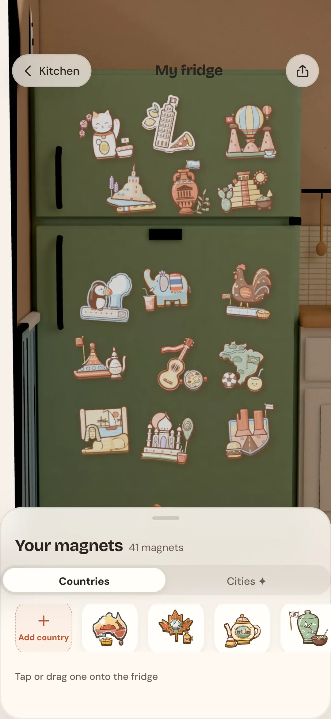 The maglo app: a green fridge door covered with country magnets, and a tray of magnets below it